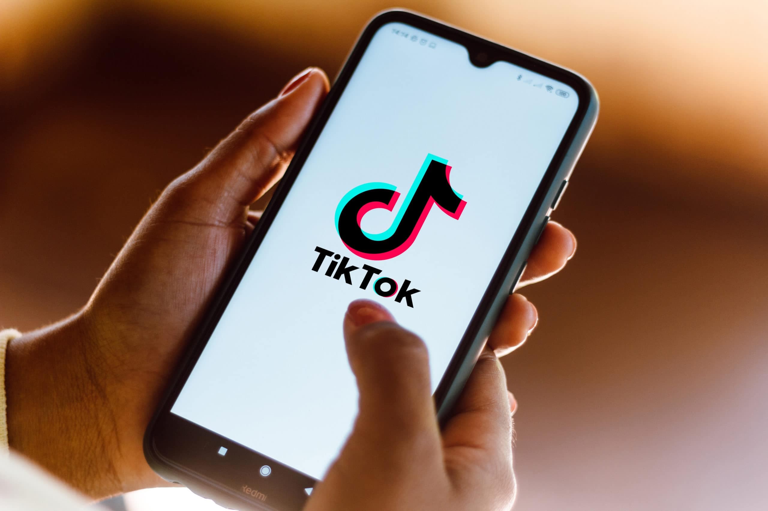 In this photo illustration the TikTok logo seen displayed on
